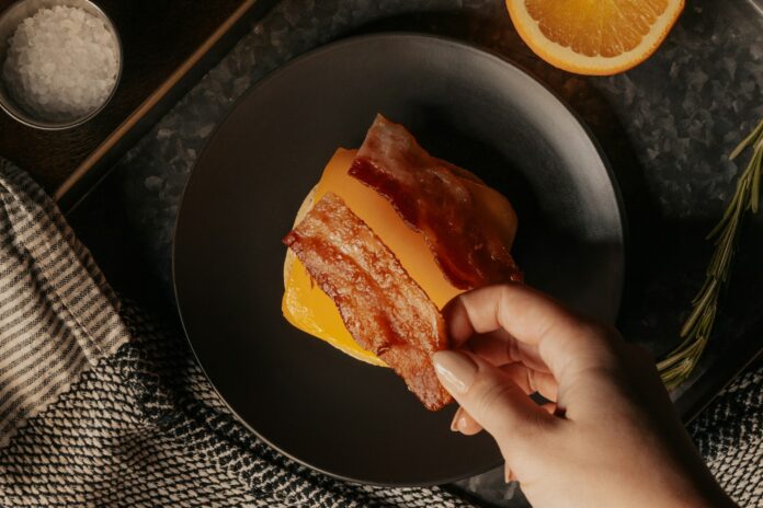 person holding a bread with sliced lemon