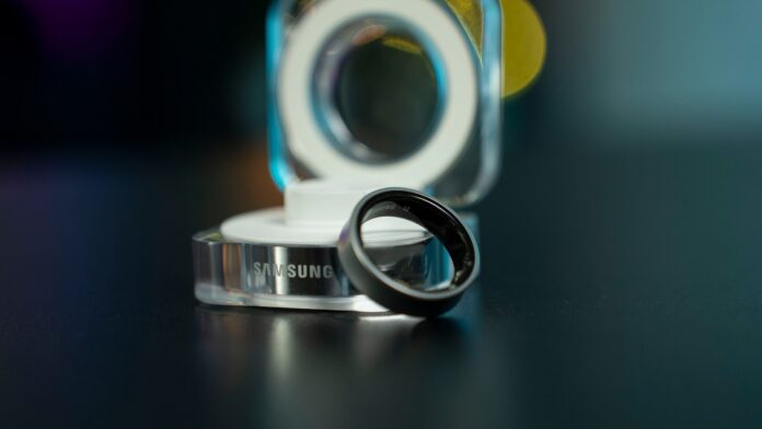 A black samsung ring with its charging dock.