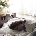 ‘잠이 보약’…일상 속 수면 혁명, 작지만 큰 변화부터 woman sleeping on bed beside book