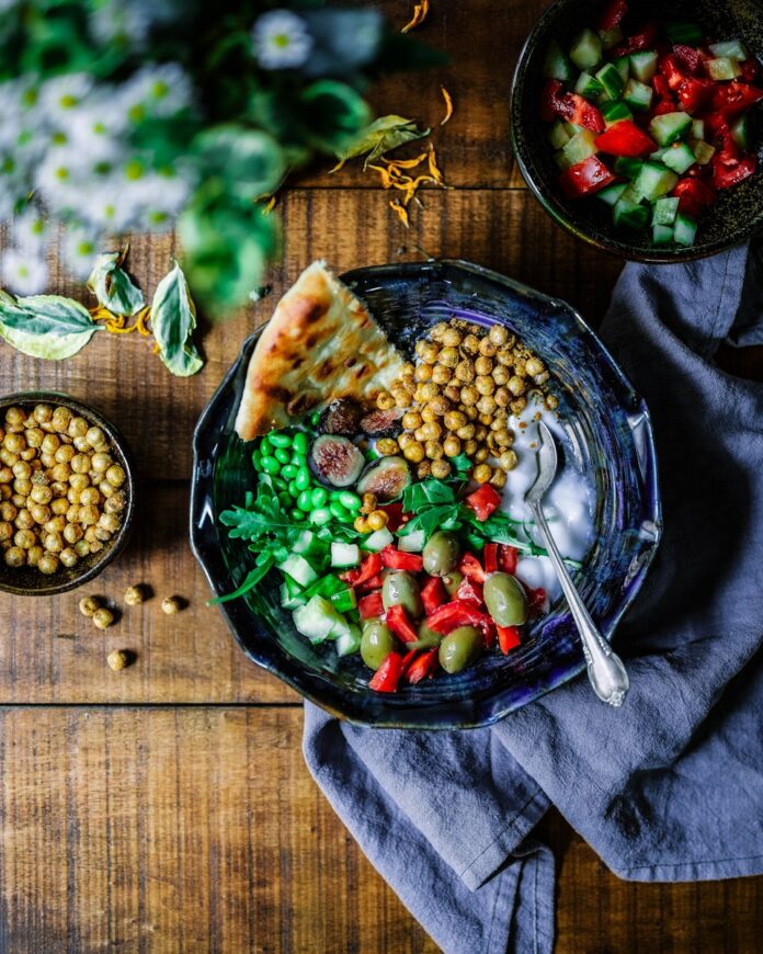 Photo by Odiseo Castrejon silver spoon on black ceramic bowl with vegetables