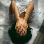 스트레스, 작지만 꾸준한 실천이 해답…한국인 맞춤 스트레스 관리법 주목 a woman holds her hands over her face