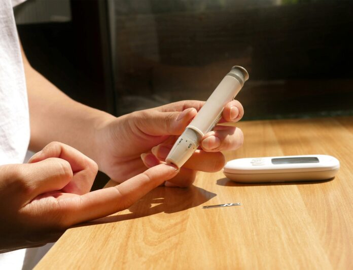 Photo by isens usa a person sitting at a table with a cell phone