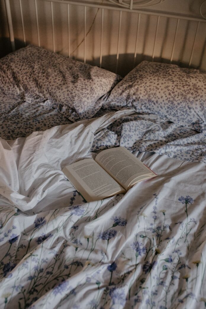 Photo by Rhamely an open book is laying on a messy bed