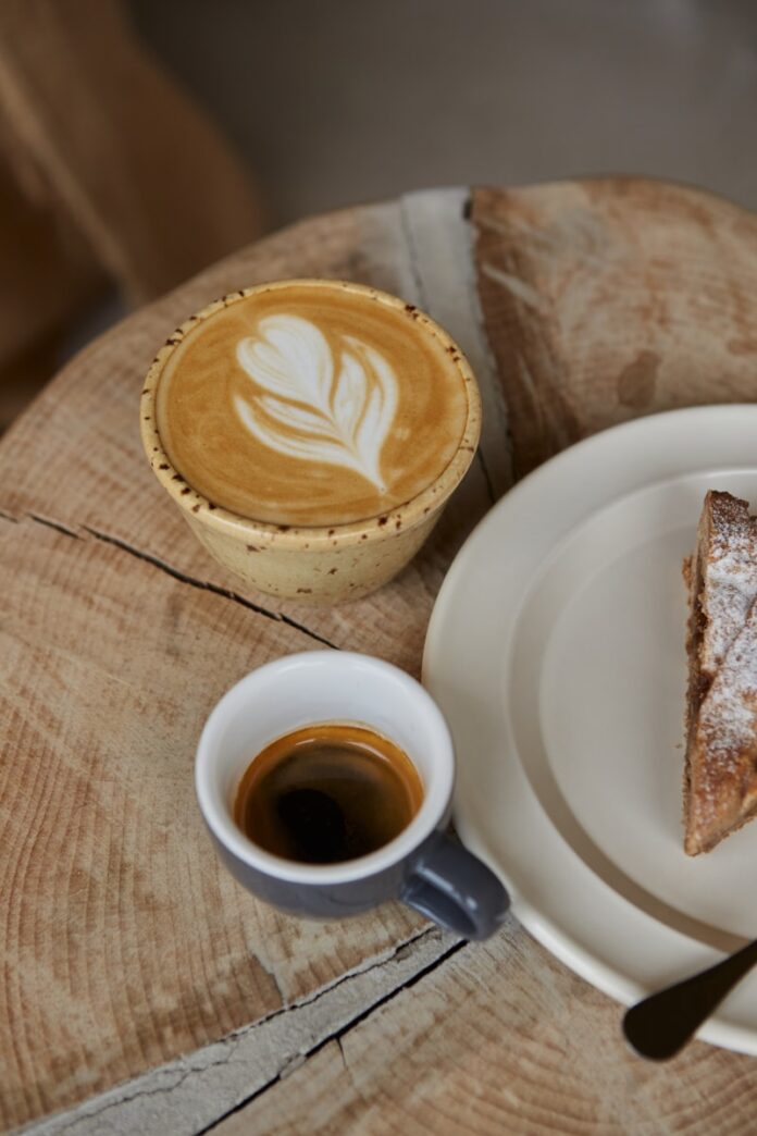 Photo by Raymond Petrik A plate with a piece of pie on it next to a cup of coffee